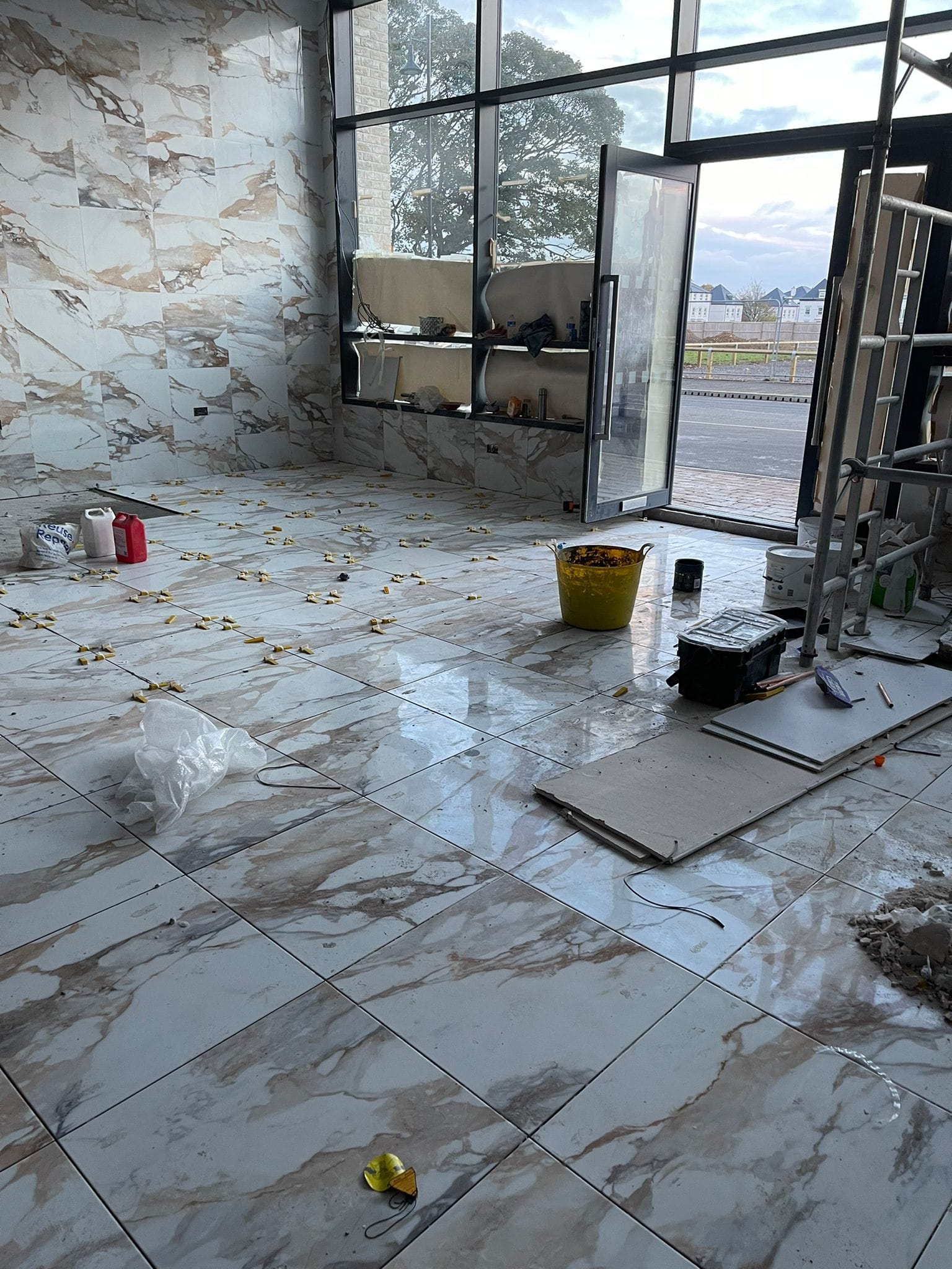 Tiling all walls and floors in a commercial property.